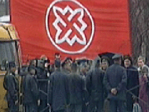 Члены РНЕ на фоне партийного флага